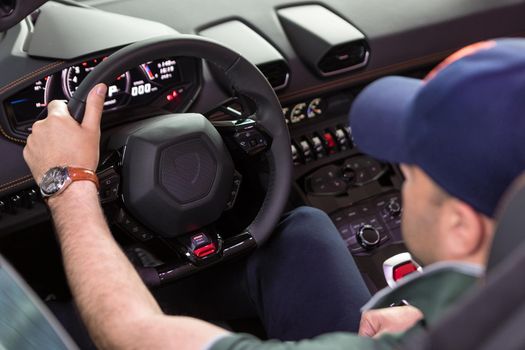 Man driving a cabriolet sports car close up