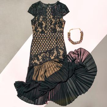 Black lace patterned bouquet dress with a necklace isolated