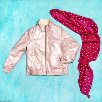 Pink woman jacket with a red scarf isolated