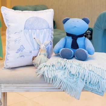 Set of colorful pillow with a bear toy on the showcase