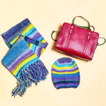 Colorful woman scarf hat and red handbag isolated