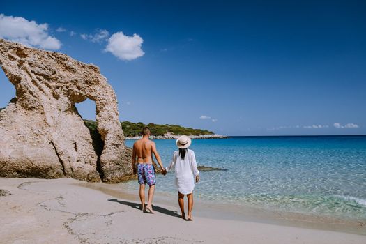 Tropical beach of Voulisma beach, Istron, Crete, Greece ,Most beautiful beaches of Crete island -Istron bay near Agios Nikolaos young couple mid age on vacation in Greece Crete