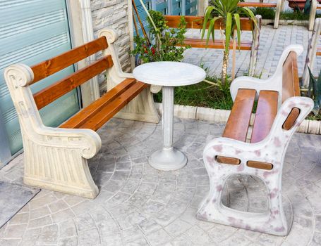 Stone, wood backyard seat at outside