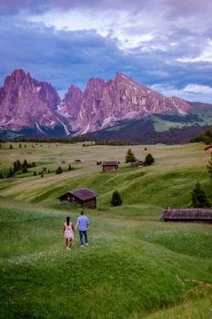 couple men and woman on vacation in the Dolomites Italy, Alpe di Siusi - Seiser Alm Dolomites, Trentino Alto Adige, South Tyrol, Italy, Europe