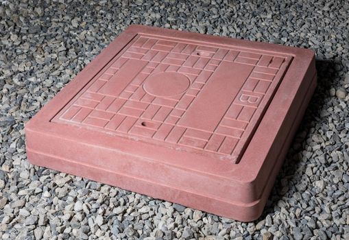 Plaster graceful stone manhole shape on the ground