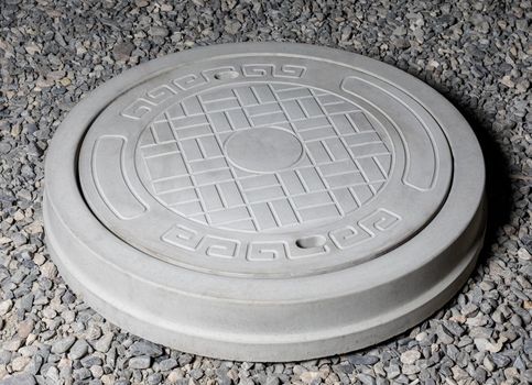 Plaster graceful stone manhole shape on the ground