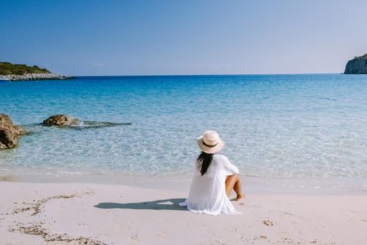 Tropical beach of Voulisma beach, Istron, Crete, Greece ,Most beautiful beaches of Crete island -Istron bay near Agios Nikolaos young asian woman mid age on vacation Greece Crete