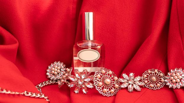 Perfume flacon with jewellery on the colorful background