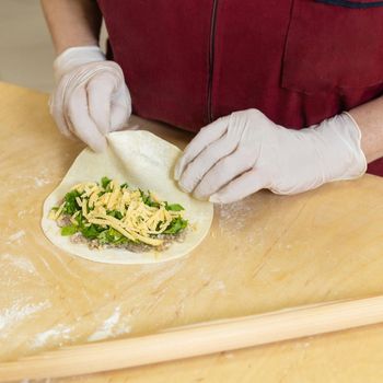 Woman making qutab meal from dough