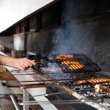 Frying fish meal, kebab in smoke