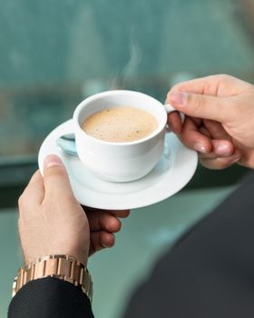 Man drinking latte coffee close up