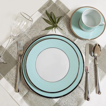 Set of clean tableware, dishes, plates, utensils on the table