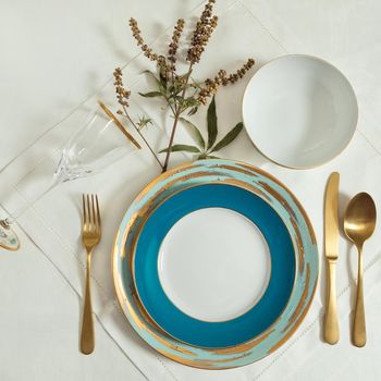 Set of clean tableware, dishes, plates, utensils on the table