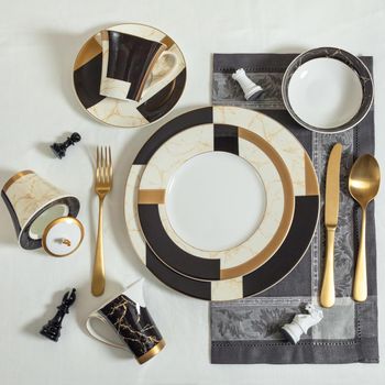 Set of clean tableware, dishes, plates, utensils on the table