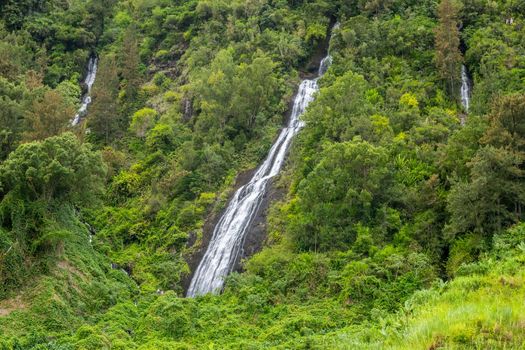 Waterfall on a green mountain at french island Reunion in the indian ocean 