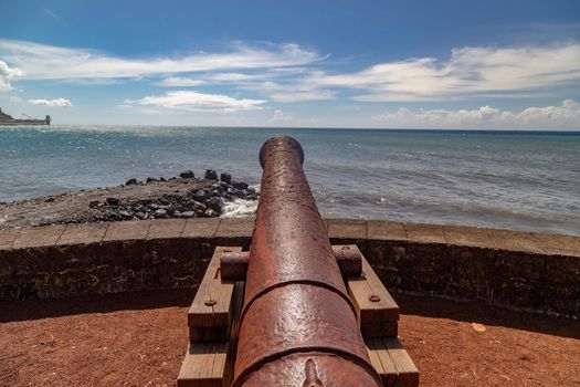 Old cannon at the waterfront of Saint Denis on Reuinion island in the Indian Ocean