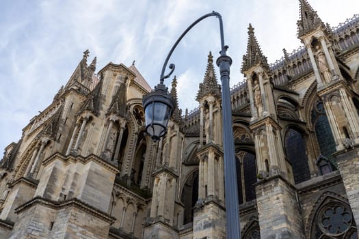 Low angle view at cathedral Notre Dame in Reims, France with street lamp in foreground
