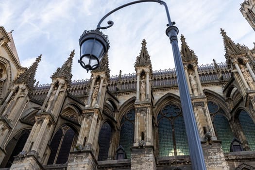 Low angle view at cathedral Notre Dame in Reims, France with street lamp in foreground