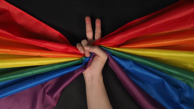 LGBTQ flag or Lesbian Gay Bi sexsual Transgender Queer or homosexsual pride Rainbow flag on black background. Represent hand symbol of freedom, peace, equality and love. LGBTQ concept