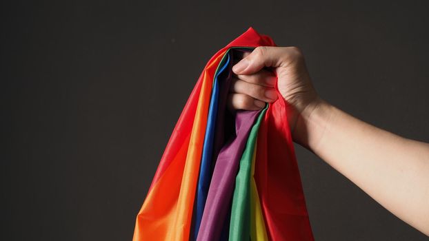 LGBTQ flag or Lesbian Gay Bi sexsual Transgender Queer or homosexsual pride Rainbow flag on black background. Represent hand symbol of freedom, peace, equality and love. LGBTQ concept