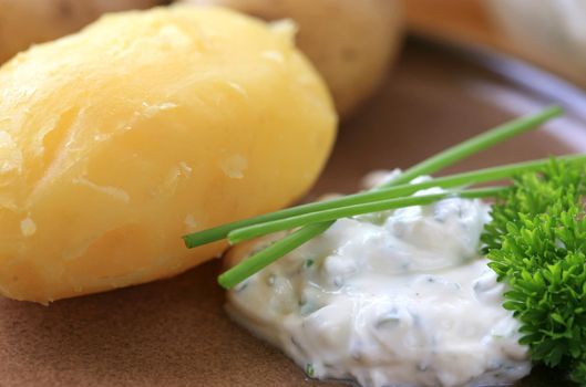 Peeled baked potato with sour cream and herbs