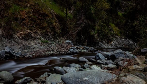 Rapid flow of the river in the mountains of the island of Cyprus at dusk.