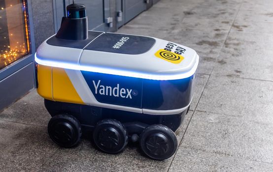 December 14, 2020, Moscow Russia. An unmanned robot courier for delivering food from the Yandex.Rover cafe at the entrance to a restaurant in Moscow.