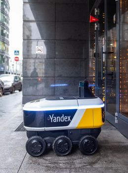 December 14, 2020, Moscow Russia. An unmanned robot courier for delivering food from the Yandex.Rover cafe at the entrance to a restaurant in Moscow.