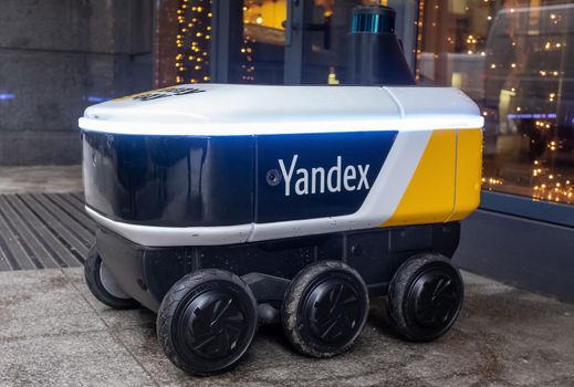 December 14, 2020, Moscow Russia. An unmanned robot courier for delivering food from the Yandex.Rover cafe at the entrance to a restaurant in Moscow.
