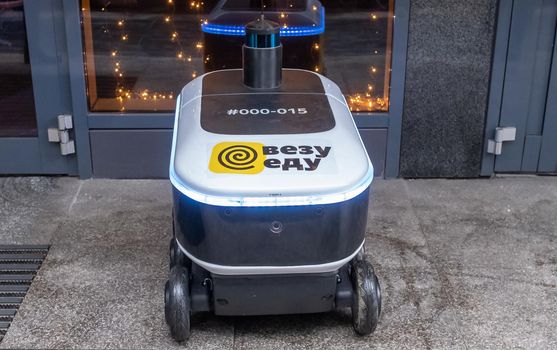 December 14, 2020, Moscow Russia. An unmanned robot courier for delivering food from the Yandex.Rover cafe at the entrance to a restaurant in Moscow.