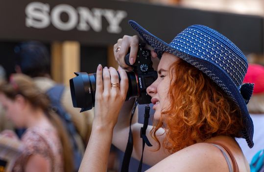 August 18, 2018. Moscow, Russia. A girl in a blue hat takes pictures with Sony's company camera.