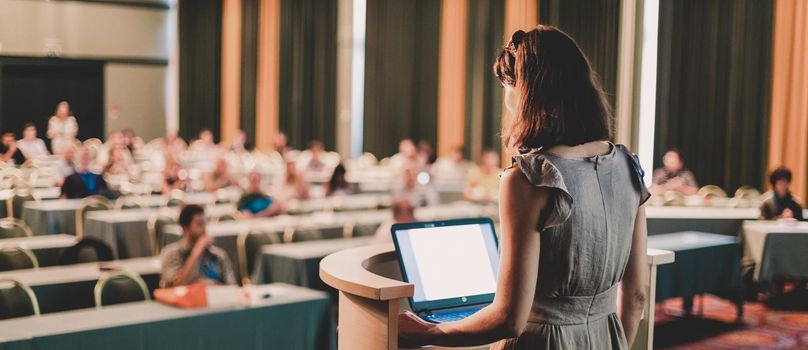 Female speaker at Business Conference and Presentation. Audience at the conference hall. Business and Entrepreneurship. Business woman. Horizontal composition.