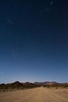 Starry night sky above a dirt road across the desert near Uspallata, Mendoza, Argentina.