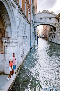 couple men and woman on a city trip to Venice Italy, colorful streets with canals Venice. Europe