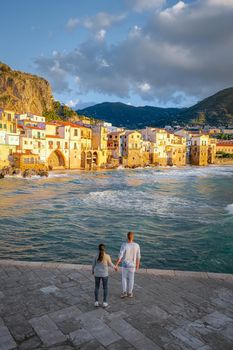 Cefalu, the medieval village of Sicily island, Province of Palermo, Italy. Europe, a couple on vacation at the Italian Island Sicilia