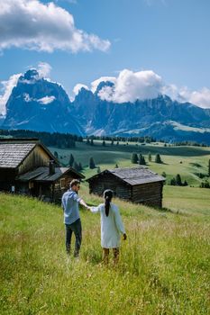 couple men and woman on vacation in the Dolomites Italy, Alpe di Siusi - Seiser Alm South Tyrol, Italy. Europe
