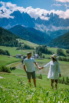 Couple on vacation Santa Magdalena Village in Dolomites area Italy, couple on vacation Val Di Funes Italian Dolomites Europe