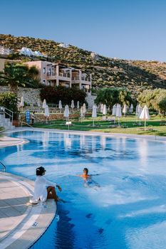 Crete Greece, Candia park village a luxury holiday village in Crete Greece by the ocean in traditional colors. Couple on vacation luxury resort