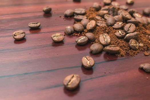 Freshly roasted coffee beans sprinkled on the table