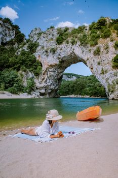 woman on the beach by the river in the Ardeche France Pont d Arc, Ardeche France,view of Narural arch in Vallon Pont D'arc in Ardeche canyon in France Europe