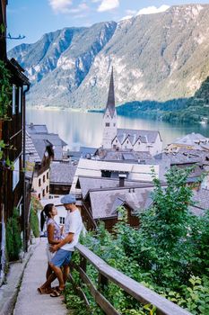 couple visit during summer vacation Hallstatt village on Hallstatter lake in Austrian Alps Austria Europe