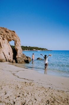 Tropical beach of Voulisma beach, Istron, Crete, Greece ,Most beautiful beaches of Crete island -Istron bay near Agios Nikolaos young couple mid age on vacation in Greece Crete