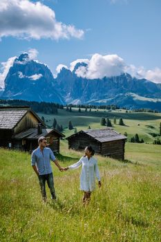 couple men and woman on vacation in the Dolomites Italy, Alpe di Siusi - Seiser Alm South Tyrol, Italy. Europe