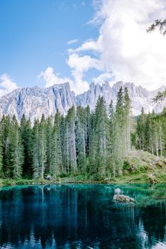 bleu lake in the dolomites Italy, Carezza lake Lago di Carezza, Karersee with Mount Latemar, Bolzano province, South tyrol, Italy. Landscape of Lake Carezza or Karersee and Dolomites in background, Nova Levante, Bolzano, Italy. Europe