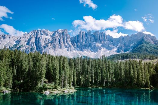 bleu lake in the dolomites Italy, Carezza lake Lago di Carezza, Karersee with Mount Latemar, Bolzano province, South tyrol, Italy. Landscape of Lake Carezza or Karersee and Dolomites in background, Nova Levante, Bolzano, Italy. Europe