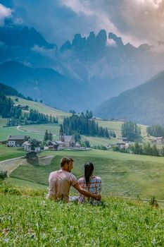 couple on vacation in the Dolomites Italy, Santa Magdalena Village in Dolomites area Italy Europe Val Di Funes