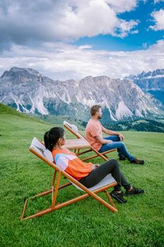 couple on vacation hiking in the Italien Dolomites, Amazing view on Seceda peak. Trentino Alto Adige, Dolomites Alps, South Tyrol, Italy, Europe.