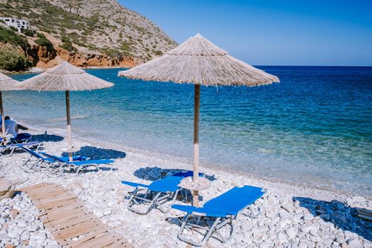 Crete Greece Plaka Lassithi with is traditional blue table and chairs and the beach in Crete Greece. Paralia Plakas, Plaka village Crete