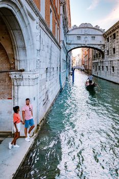 couple men and woman on a city trip to Venice Italy, colorful streets with canals Venice. Europe