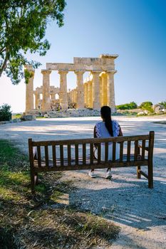 A couple visit Greek temples at Selinunte during vacation, View on sea and ruins of greek columns in Selinunte Archaeological Park Sicily Italy